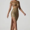 Abito lungo asimmetrico con cut-out e decorazioni Persephone in oro Abito lungo asimmetrico con cut-out e decorazioni Persephone in oro