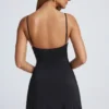 Abito mini svasato Deia con dettagli metallici in nero Abito mini svasato Deia con dettagli metallici in nero