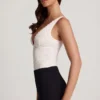 Body Zayla in pizzo trasparente con scollo a V smerlato, colore bianco Body Zayla in pizzo trasparente con scollo a V smerlato, colore bianco