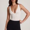 Body Zayla in pizzo trasparente con scollo a V smerlato, colore bianco Body Zayla in pizzo trasparente con scollo a V smerlato, colore bianco