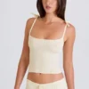 Canotta con lacci in maglia a costine color crema Canotta con lacci in maglia a costine color crema