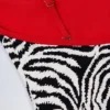 Costume intero Ostend con incrocio sulla schiena e dettagli a forma di ciondolo in stampa zebrata Costume intero Ostend con incrocio sulla schiena e dettagli a forma di ciondolo in stampa zebrata