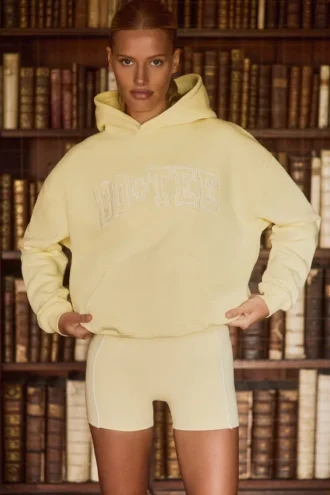 Felpa con cappuccio oversize ricamata in giallo tenue
