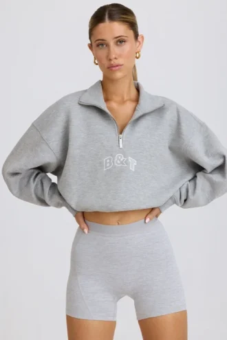 Felpa corta con zip a un quarto in grigio melange