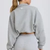 Felpa corta con zip a un quarto in grigio melange