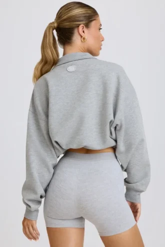Felpa corta con zip a un quarto in grigio melange