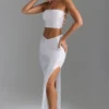 Gonna lunga Pelagia con spacco sulla coscia e vita a V decorata in bianco Gonna lunga Pelagia con spacco sulla coscia e vita a V decorata in bianco