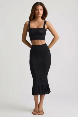Gonna midi Yasira in maglia pointelle con bordi arricciati, colore nero Gonna midi Yasira in maglia pointelle con bordi arricciati, colore nero