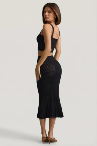 Gonna midi Yasira in maglia pointelle con bordi arricciati, colore nero Gonna midi Yasira in maglia pointelle con bordi arricciati, colore nero
