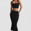 Gonna midi Yasira in maglia pointelle con bordi arricciati, colore nero Gonna midi Yasira in maglia pointelle con bordi arricciati, colore nero