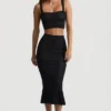 Gonna midi Yasira in maglia pointelle con bordi arricciati, colore nero Gonna midi Yasira in maglia pointelle con bordi arricciati, colore nero