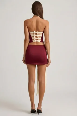 Mini gonna a vita bassa con fiocco in raso Carola in rosso vino