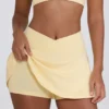 Mini gonna-pantaloncino incrociata in jersey spazzolato melange limone Mini gonna-pantaloncino incrociata in jersey spazzolato melange limone