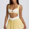 Mini gonna-pantaloncino plissettata Soft Active con incrocio in giallo limone