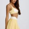 Mini gonna-pantaloncino plissettata Soft Active con incrocio in giallo limone