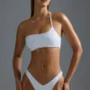 Oh Polly Costumi da Bagno: Top bikini a fascia monospalla decorato HOTFIX Edition in bianco Oh Polly Costumi da Bagno: Top bikini a fascia monospalla decorato HOTFIX Edition in bianco