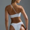 Oh Polly Costumi da Bagno: Top bikini a fascia monospalla decorato HOTFIX Edition in bianco Oh Polly Costumi da Bagno: Top bikini a fascia monospalla decorato HOTFIX Edition in bianco