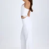 Pantaloni a gamba larga con cut-out e cintura Zaria in bianco Pantaloni a gamba larga con cut-out e cintura Zaria in bianco