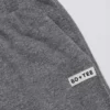 Pantaloni da jogging a vita bassa e gamba larga in cotone testurizzato con bottoni, colore grigio scuro Pantaloni da jogging a vita bassa e gamba larga in cotone testurizzato con bottoni, colore grigio scuro