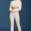 Pantaloni svasati con risvolto in maglia a trecce color crema Pantaloni svasati con risvolto in maglia a trecce color crema