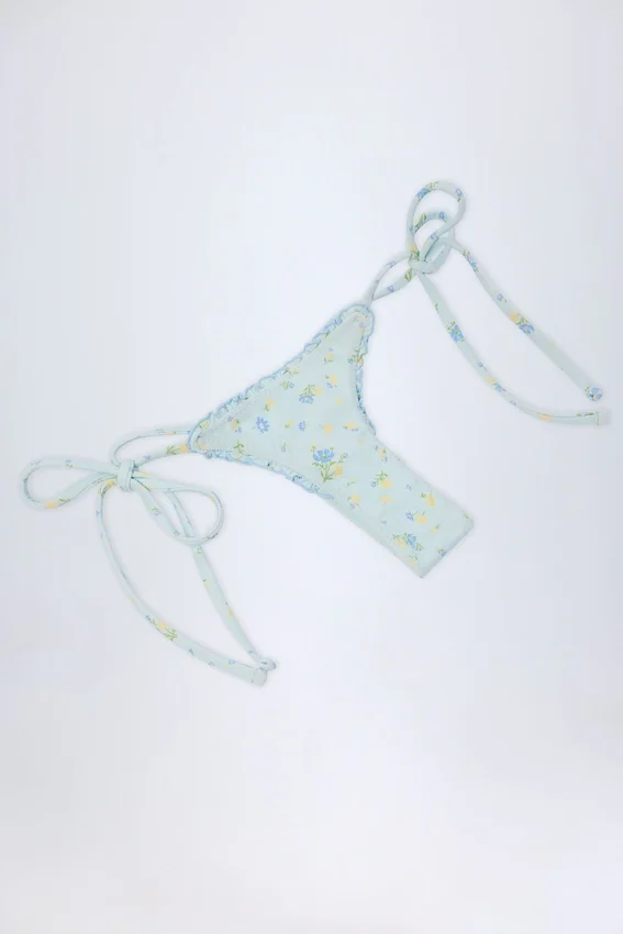 Slip Bikini con lacci laterali Nieva in blu floreale Slip Bikini con lacci laterali Nieva in blu floreale