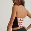 Top a corsetto con cut-out e fiocco Audrina in nero Top a corsetto con cut-out e fiocco Audrina in nero