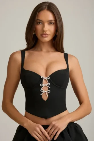 Top a corsetto con cut-out e fiocco Pearla in nero