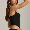 Top a corsetto con cut-out e fiocco Pearla in nero Top a corsetto con cut-out e fiocco Pearla in nero