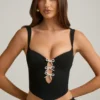 Top a corsetto con cut-out e fiocco Pearla in nero Top a corsetto con cut-out e fiocco Pearla in nero