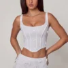 Top a corsetto con lacci e decorazioni Letitia in bianco