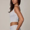 Top a corsetto con lacci e decorazioni Letitia in bianco