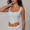 Top a corsetto con lacci e decorazioni Letitia in bianco
