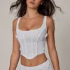 Top a corsetto con lacci e decorazioni Letitia in bianco