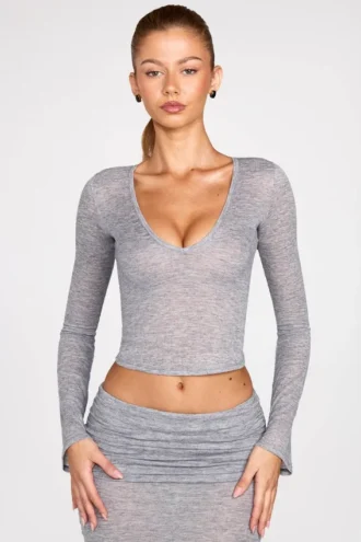 Top a maniche lunghe con scollo profondo in jersey trasparente Liah, colore grigio