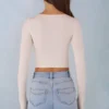 Top a reggiseno con lacci a maniche lunghe in modal a coste Margaux in avorio Top a reggiseno con lacci a maniche lunghe in modal a coste Margaux in avorio