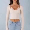Top a reggiseno con lacci a maniche lunghe in modal a coste Margaux in avorio Top a reggiseno con lacci a maniche lunghe in modal a coste Margaux in avorio