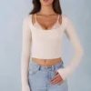 Top a reggiseno con lacci a maniche lunghe in modal a coste Margaux in avorio Top a reggiseno con lacci a maniche lunghe in modal a coste Margaux in avorio