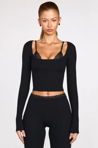 Top a reggiseno con lacci a maniche lunghe in modal a coste Margaux in nero