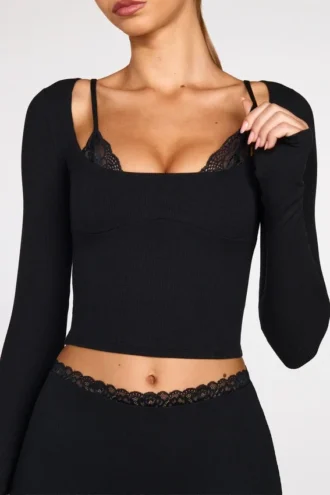 Top a reggiseno con lacci a maniche lunghe in modal a coste Margaux in nero