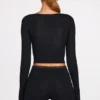 Top a reggiseno con lacci a maniche lunghe in modal a coste Margaux in nero Top a reggiseno con lacci a maniche lunghe in modal a coste Margaux in nero