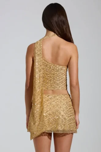 Top asimmetrico con dettagli a sciarpa decorato Cosette in oro
