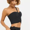 Top asimmetrico in jersey elasticizzato con dettagli a rosa di Tesia in nero Top asimmetrico in jersey elasticizzato con dettagli a rosa di Tesia in nero