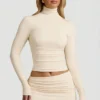 Top Auri in Modal con collo alto, ruches e schiena scoperta, colore avorio Top Auri in Modal con collo alto, ruches e schiena scoperta, colore avorio