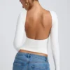 Top bianco a collo alto con maniche lunghe e schiena scoperta in modal Elli