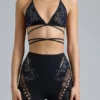 Top bikini con spalline incrociate e decorazioni Liberty in nero Top bikini con spalline incrociate e decorazioni Liberty in nero