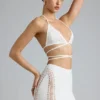 Top bikini Liberty con spalline incrociate e decorazioni in avorio Top bikini Liberty con spalline incrociate e decorazioni in avorio