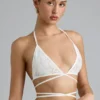 Top bikini Liberty con spalline incrociate e decorazioni in avorio Top bikini Liberty con spalline incrociate e decorazioni in avorio