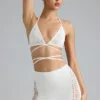 Top bikini Liberty con spalline incrociate e decorazioni in avorio Top bikini Liberty con spalline incrociate e decorazioni in avorio