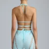 Top bikini Liberty con spalline incrociate e decorazioni in blu ghiaccio Top bikini Liberty con spalline incrociate e decorazioni in blu ghiaccio