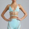 Top bikini Liberty con spalline incrociate e decorazioni in blu ghiaccio Top bikini Liberty con spalline incrociate e decorazioni in blu ghiaccio